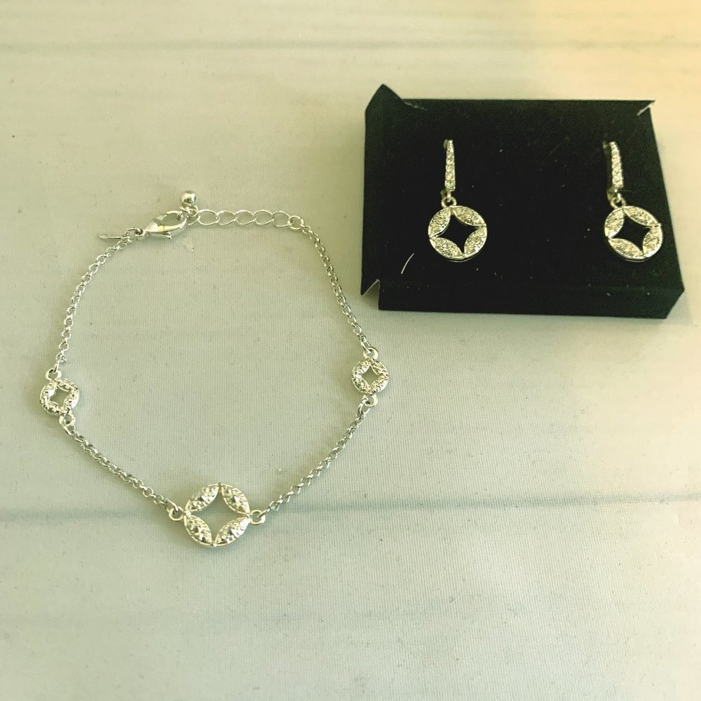 Avon silver toned bracelet and drop earrings. NIB
